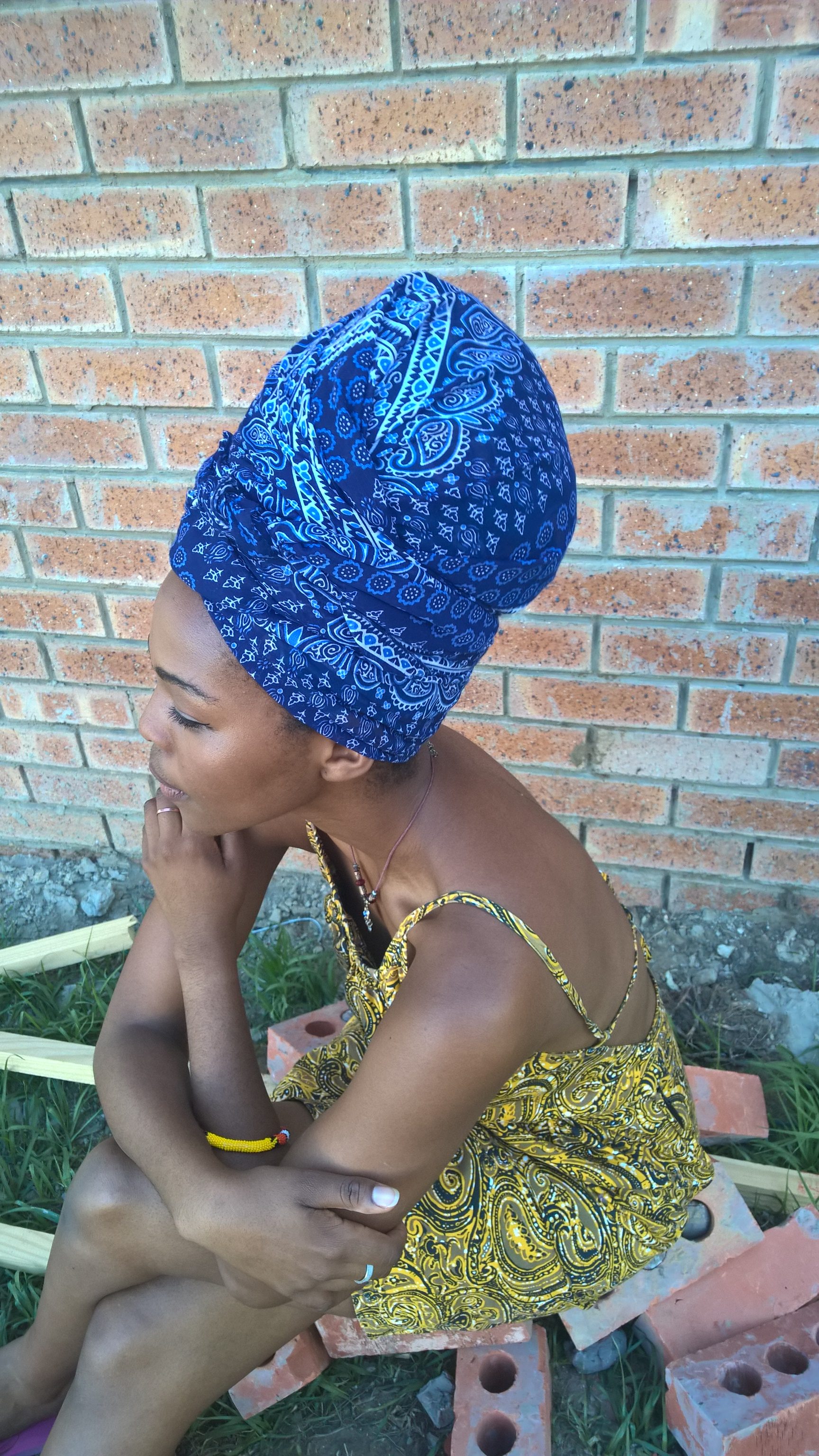 Hair tucked under Ma's new blue scarf, she became The Thinker